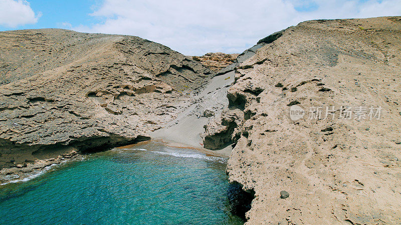 Aerial view of the hidden cove beach "La Rajita" at the natural reserve of "Monta?a Pelada" in Tenerife (Canary Islands). Drone shot